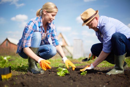 Supervisor checking safety procedures for a gardening task